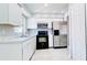 Kitchen features stainless steel appliances, white cabinets, and neutral countertops with black oven at 3362 Janet St, Apopka, FL 32712