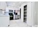 Bright kitchen featuring white cabinets, stainless steel appliances, and tiled floors at 3362 Janet St, Apopka, FL 32712