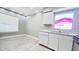 Bright kitchen featuring white cabinets, stainless steel appliances, and tiled floors at 3362 Janet St, Apopka, FL 32712