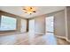 Open-plan living room with ceiling fan, entry door and wood-look floors at 3362 Janet St, Apopka, FL 32712