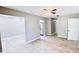Open-concept living room featuring wood-look tile flooring, gray walls, and a ceiling fan with a light fixture at 3362 Janet St, Apopka, FL 32712