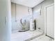 Utility room with water heater, small window, and white marble-look tiled floor at 3362 Janet St, Apopka, FL 32712