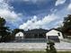 Backyard view of house with screened pool, paved patio and landscaping at 3417 Bay Meadow Ct, Windermere, FL 34786