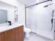 Modern bathroom features a wood vanity, black fixtures, and glass-enclosed shower at 3417 Bay Meadow Ct, Windermere, FL 34786