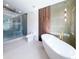 Stunning bathroom featuring a glass shower, modern soaking tub, and sleek fixtures at 3417 Bay Meadow Ct, Windermere, FL 34786
