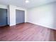 Bedroom featuring wood-look floors, base trim, and a grey closet at 3417 Bay Meadow Ct, Windermere, FL 34786