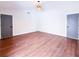 Spacious primary bedroom featuring hardwood floors, modern lighting, and two doors at 3417 Bay Meadow Ct, Windermere, FL 34786