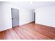A bright bedroom with hardwood floors, white walls and trim, and a modern gray door at 3417 Bay Meadow Ct, Windermere, FL 34786
