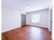 A bright bedroom with hardwood floors, white walls and trim, and a window at 3417 Bay Meadow Ct, Windermere, FL 34786