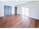 Spacious bedroom featuring wood floors, closet, and sliding glass doors to outdoor space at 3417 Bay Meadow Ct, Windermere, FL 34786