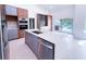 Modern kitchen featuring a large island, stainless steel appliances, and view of the outdoor pool area at 3417 Bay Meadow Ct, Windermere, FL 34786