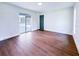 Bright living room with wood-look floors and sliding doors to the pool at 3417 Bay Meadow Ct, Windermere, FL 34786