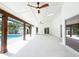 Spacious covered patio with ceiling fans, offering views of the backyard swimming pool at 3417 Bay Meadow Ct, Windermere, FL 34786