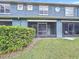 Exterior view of the back of the home showing a private screened patio and landscaped yard at 3559 Victoria Pines Dr # 280, Orlando, FL 32829