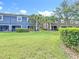 Backyard view of townhomes with well-manicured lawns and lush landscaping at 3559 Victoria Pines Dr # 280, Orlando, FL 32829