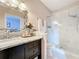 Bathroom featuring a marble countertop, a glass-enclosed shower, and decorative mirror at 3559 Victoria Pines Dr # 280, Orlando, FL 32829