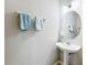 Charming bathroom featuring pedestal sink, decorative mirror, and soft blue accent towels at 3559 Victoria Pines Dr # 280, Orlando, FL 32829