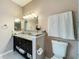 Bathroom with marble countertop, decorative mirror, white towels and neutral paint at 3559 Victoria Pines Dr # 280, Orlando, FL 32829