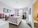 Charming bedroom with lilac walls, a stylish bed, carpet flooring, and ample natural light at 3559 Victoria Pines Dr # 280, Orlando, FL 32829