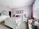 Bedroom featuring lilac walls, a stylish bed, ample natural light, and carpet flooring at 3559 Victoria Pines Dr # 280, Orlando, FL 32829