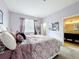 Stylish bedroom features a plush queen bed, and a view into the ensuite bathroom at 3559 Victoria Pines Dr # 280, Orlando, FL 32829