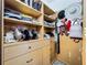 Organized walk-in closet featuring custom shelves, drawers, rods, and hanging storage for accessories at 3559 Victoria Pines Dr # 280, Orlando, FL 32829