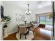 Bright dining area with stylish furniture, decorative wall art, and a view into the living room at 3559 Victoria Pines Dr # 280, Orlando, FL 32829