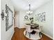 Elegant dining area with a round table, chandelier, and view into other rooms at 3559 Victoria Pines Dr # 280, Orlando, FL 32829