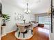 Inviting dining room with hardwood floors, stylish chandelier, round table set, and sliding door access to the backyard at 3559 Victoria Pines Dr # 280, Orlando, FL 32829