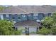 Exterior view of blue townhomes with charming architectural details and lush greenery at 3559 Victoria Pines Dr # 280, Orlando, FL 32829