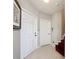 Bright foyer with tiled flooring, white doors, and a staircase leading to the upper level at 3559 Victoria Pines Dr # 280, Orlando, FL 32829