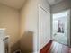 Hallway features hardwood floors, neutral paint, closet, and doorway into bedroom at 3559 Victoria Pines Dr # 280, Orlando, FL 32829