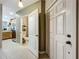 Bright hallway view leading to kitchen and half bath, showcasing tile flooring and neutral paint at 3559 Victoria Pines Dr # 280, Orlando, FL 32829