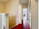 Upstairs hallway with hardwood floors and a view into another room at 3559 Victoria Pines Dr # 280, Orlando, FL 32829