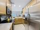 Well-lit kitchen with stainless steel appliances, mosaic backsplash, and view of the dining area at 3559 Victoria Pines Dr # 280, Orlando, FL 32829