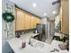 Charming kitchen featuring stainless steel appliances, ample counter space, and a view into the hallway at 3559 Victoria Pines Dr # 280, Orlando, FL 32829