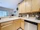 Well-lit kitchen with stainless steel appliances, light wood cabinets, and a breakfast bar at 3559 Victoria Pines Dr # 280, Orlando, FL 32829