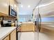 Bright kitchen with stainless steel appliances, light wood cabinets, and mosaic backsplash at 3559 Victoria Pines Dr # 280, Orlando, FL 32829