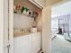 Convenient laundry area featuring a washer, a dryer, and shelving for storage at 3559 Victoria Pines Dr # 280, Orlando, FL 32829