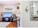 Cozy living room featuring hardwood floors, a mounted television, barstool seating, and decorative mirror at 3559 Victoria Pines Dr # 280, Orlando, FL 32829