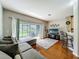 Comfortable living room with plush seating, sliding glass doors to patio, and entertainment center at 3559 Victoria Pines Dr # 280, Orlando, FL 32829