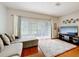 Bright living room with hardwood floors, large windows, comfortable sectional couch, and mounted television at 3559 Victoria Pines Dr # 280, Orlando, FL 32829