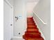 Wooden staircase featuring white handrails and a white entry door at 3559 Victoria Pines Dr # 280, Orlando, FL 32829