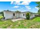 The backyard presents a well-maintained lawn and a clear view of the home's exterior at 3716 Neptune Dr, Orlando, FL 32804