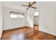 This bedroom features hardwood floors, a ceiling fan, and a closet at 3716 Neptune Dr, Orlando, FL 32804