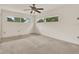 Spacious bedroom with neutral carpet, ceiling fan, and natural light at 3716 Neptune Dr, Orlando, FL 32804