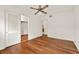 This bedroom features hardwood floors, a ceiling fan, and a closet at 3716 Neptune Dr, Orlando, FL 32804