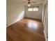 Bedroom featuring neutral walls, hardwood floors, closet and natural light from a window at 3716 Neptune Dr, Orlando, FL 32804