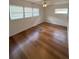 Cozy bedroom featuring neutral walls, hardwood floors, and natural light from the window at 3716 Neptune Dr, Orlando, FL 32804