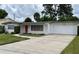 Welcoming single-story home featuring a well-maintained lawn, driveway and charming red front door at 3716 Neptune Dr, Orlando, FL 32804